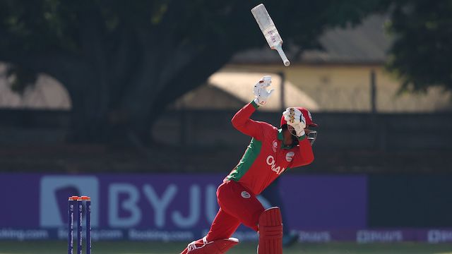 Ayaan Khan lets go of his bat during Oman's qualifier game against Sri Lanka.